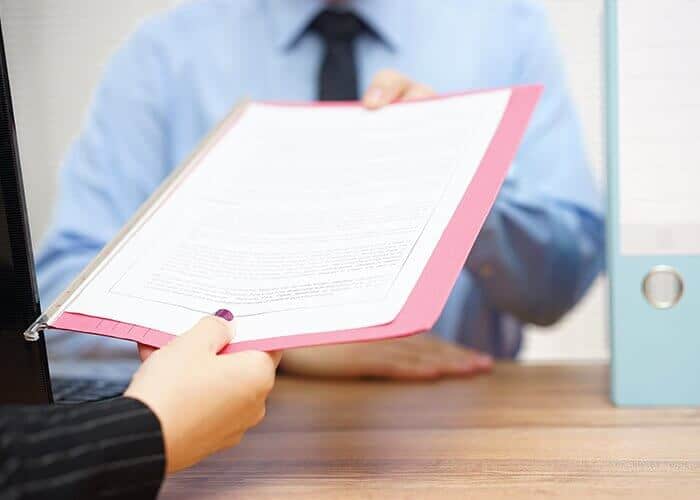 Lawyer presenting a client with a document.